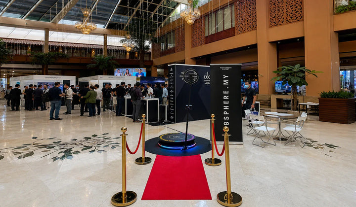 Event photo booth setup with a 360 booth platform, lighting, and backdrop