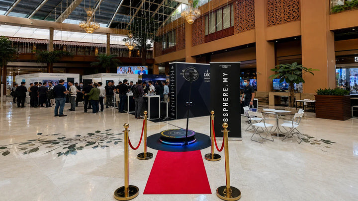 Event photo booth setup with a 360 booth platform, lighting, and backdrop