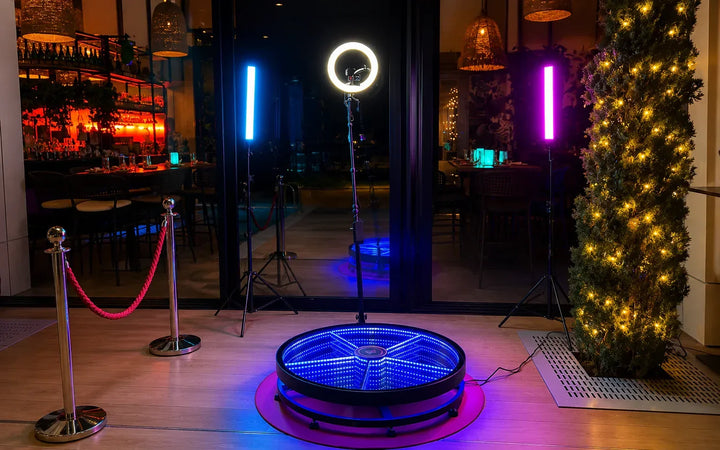 360 photo booth setup with illuminated platform and event lighting