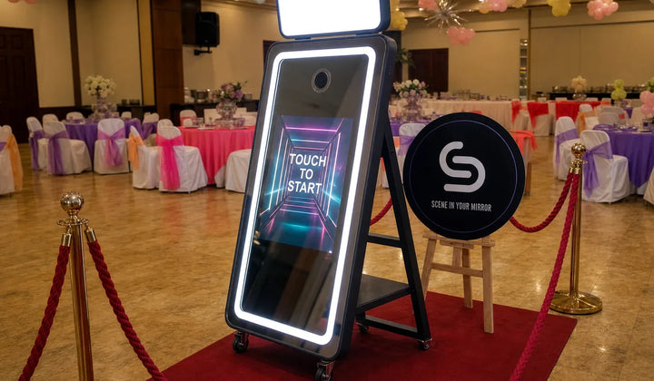 Mirror photo booth setup at an event venue with a red carpet