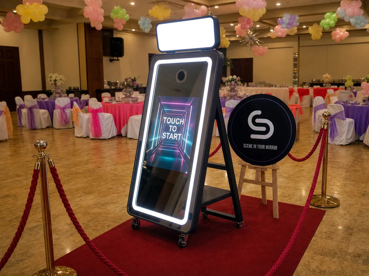 Mirror photo booth setup at an event venue with a red carpet