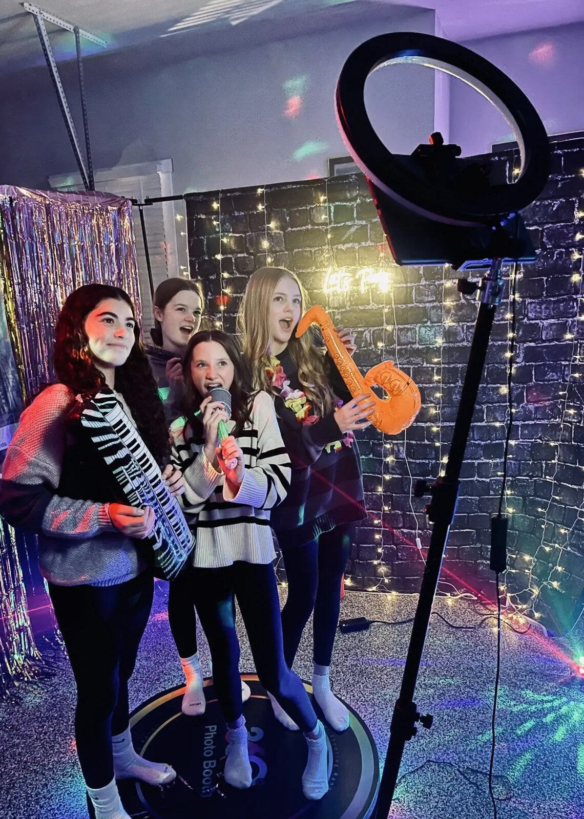 Guests using a Spin Metal 360 photo booth at an event.