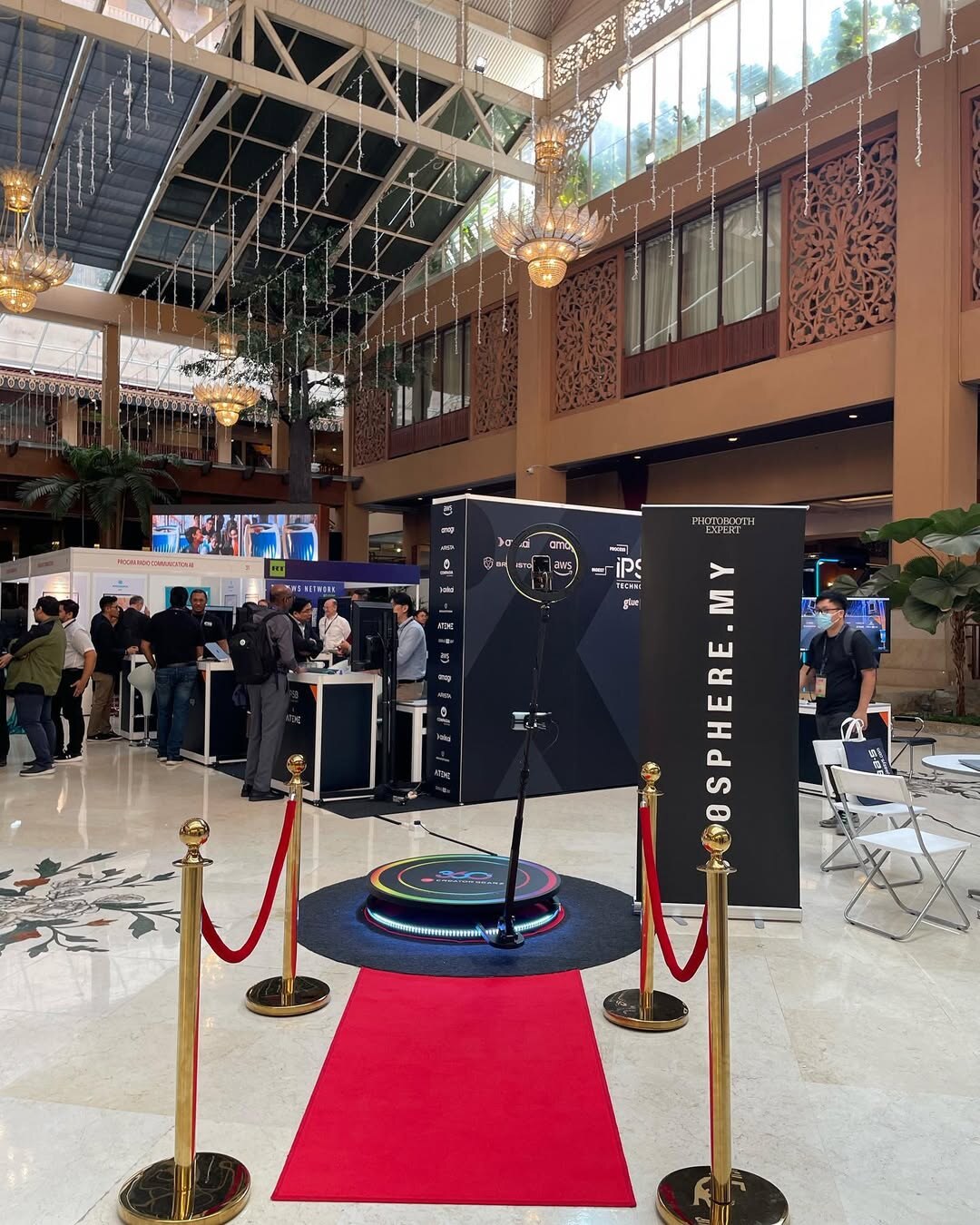 Spin Metal 360 photo booth with a red carpet at a trade show.